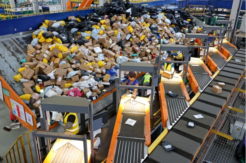 Empleados clasifican paquetes en un centro de logística de la sucursal de Zaozhuang de China Post, en la ciudad de Zaozhuang, en la provincia de Shandong, en el este de China, el 11 de noviembre de 2024. (Xinhua/Sun Zhongzhe) 
